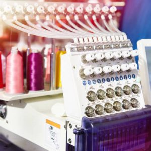 Embroidery industrial machine in sewing workshop