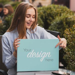 beautiful-blonde-girl-holding-banner-mock-up_23-2148362460